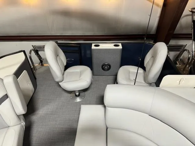 Slide: The Image of 2024 Crest Classic LX 200 C4 boat interior with plush seating and modern design. - 4