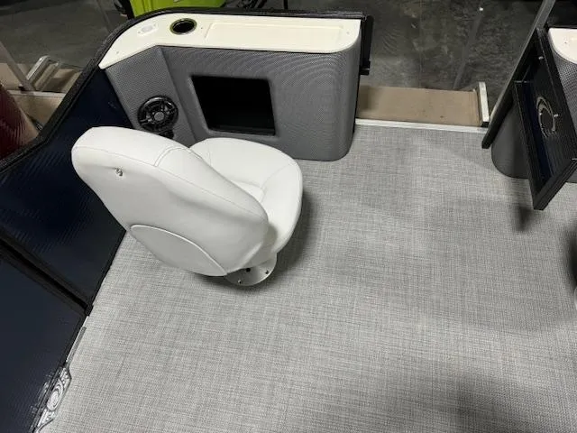Slide: The Image of 2024 Crest Classic LX 200 C4 boat interior with white captain's chair and gray flooring. - 6