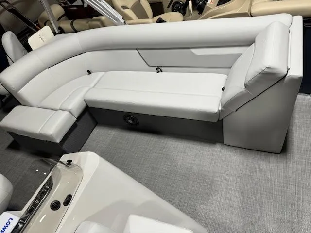 Slide: The Image of 2024 Crest Classic LX 200 C4 pontoon boat interior with white cushioned seating. - 7