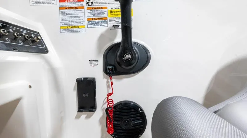 Slide: The Image of 2024 Bayliner DX 2000 boat control panel with throttle and safety features. - 14