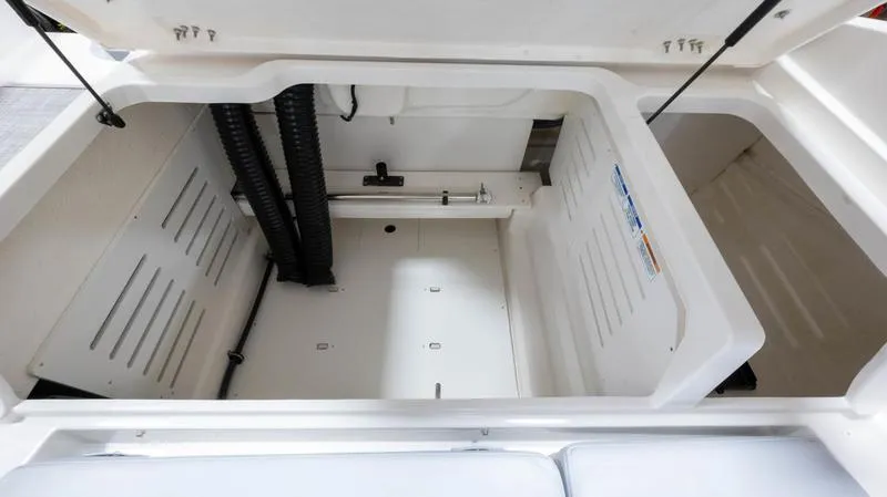 Slide: The Image of 2024 Bayliner DX 2000 storage compartment, open and spacious with white interior. - 21