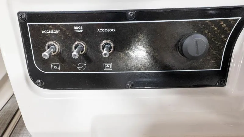 Slide: The Image of Control panel of 2024 Bayliner DX 2000 boat with accessory and bilge pump switches. - 24