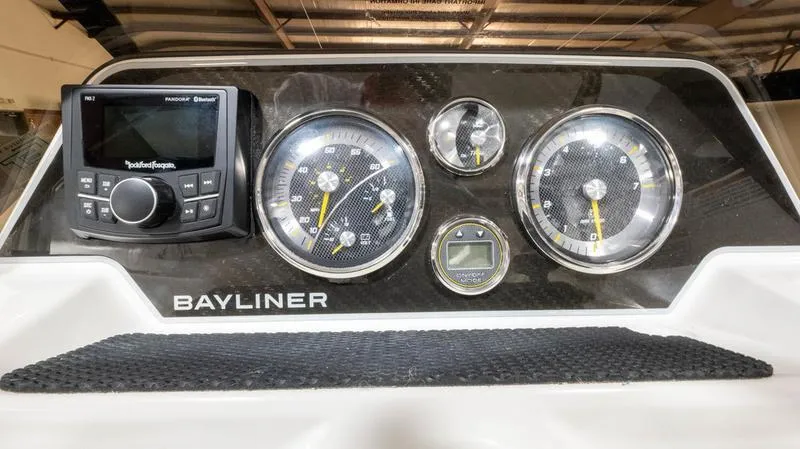 Slide: The Image of Dashboard of 2024 Bayliner DX 2000 boat with gauges and Rockford Fosgate audio system. - 25