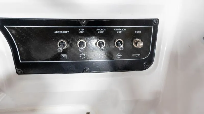 Slide: The Image of Control panel of 2024 Bayliner DX 2000 boat with switches for lights and horn. - 26