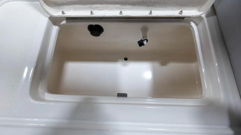 Slide: The Image of 2024 Bayliner DX 2000 storage compartment with open lid, showcasing interior space. - 29