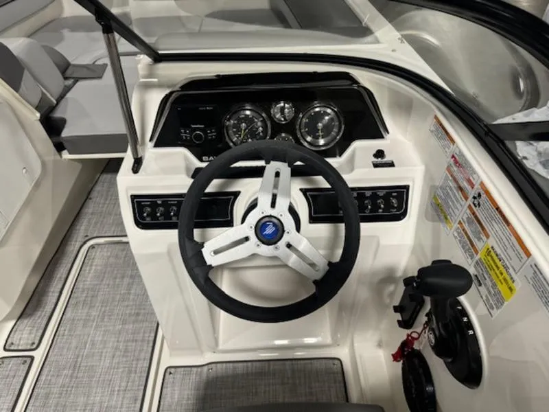 Slide: The Image of 2024 Bayliner DX 2000 boat dashboard with steering wheel and control panel. - 30