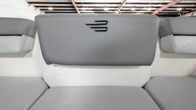 Slide: The Image of 2024 Bayliner DX 2000 boat interior with gray cushioned seating and modern design. - 32