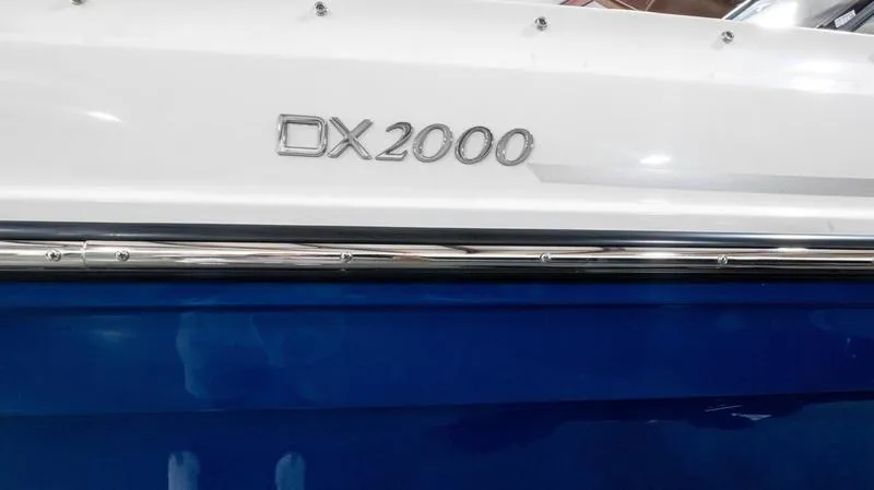 Slide: The Image of 2024 Bayliner DX 2000 boat, white and blue exterior detail. - 5