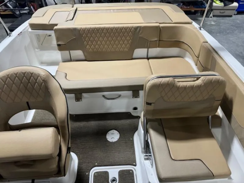 Slide: The Image of 2024 Bayliner VR5 Bowrider Outboard interior with tan seating and diamond stitching. - 4