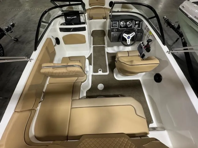 Slide: The Image of 2024 Bayliner VR5 Bowrider Outboard interior with tan seating and modern dashboard. - 6