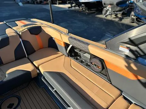 Slide: The Image of 2024 MasterCraft XT24 boat interior with tan and orange seating. - 10