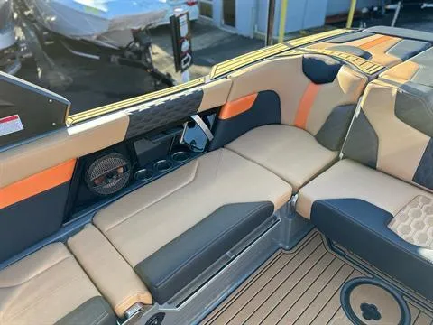 Slide: The Image of 2024 MasterCraft XT24 boat interior with tan and black seating. - 11