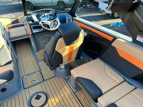 Slide: The Image of 2024 MasterCraft XT24 boat interior with modern seating and dashboard. - 12
