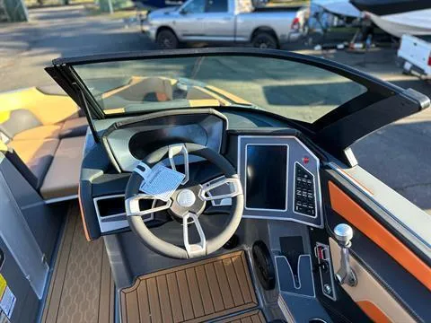 Slide: The Image of 2024 MasterCraft XT24 boat cockpit with modern steering wheel and control panel. - 14