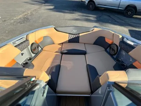 Slide: The Image of 2024 MasterCraft XT24 boat interior with tan and black seating. - 15