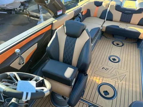 Slide: The Image of 2024 MasterCraft XT24 boat interior with luxury seating and modern design. - 16