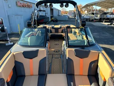 Slide: The Image of 2024 MasterCraft XT24 boat interior with orange and black seating. - 18