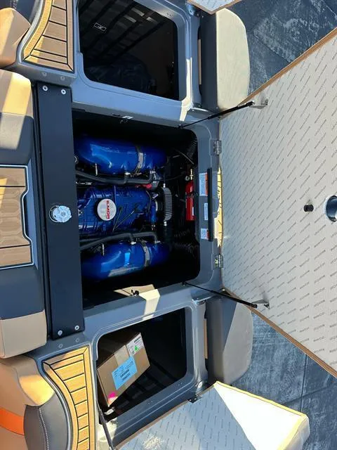 Slide: The Image of 2024 MasterCraft XT24 boat engine compartment with open hatches. - 19