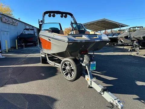 Slide: The Image of 2024 MasterCraft XT24 boat on trailer in dealership lot. - 5
