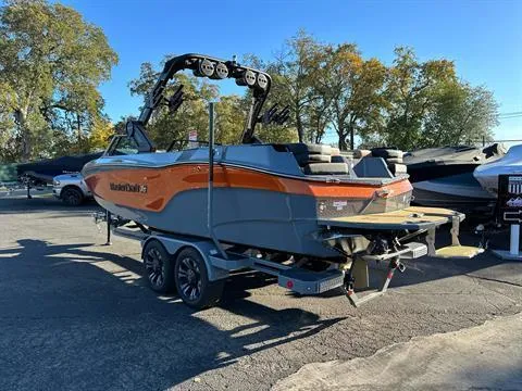 Slide: The Image of 2024 MasterCraft XT24 boat on trailer, orange and gray, outdoor display. - 7
