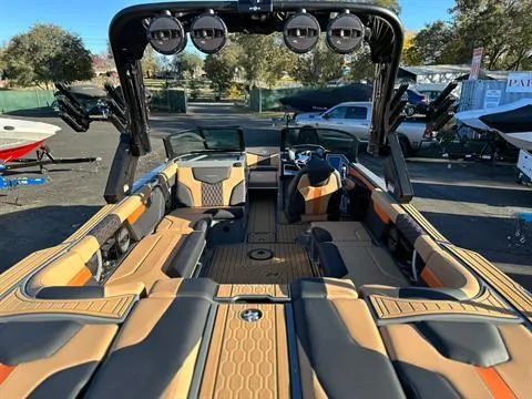 Slide: The Image of 2024 MasterCraft XT24 boat interior with luxurious seating and advanced sound system. - 8