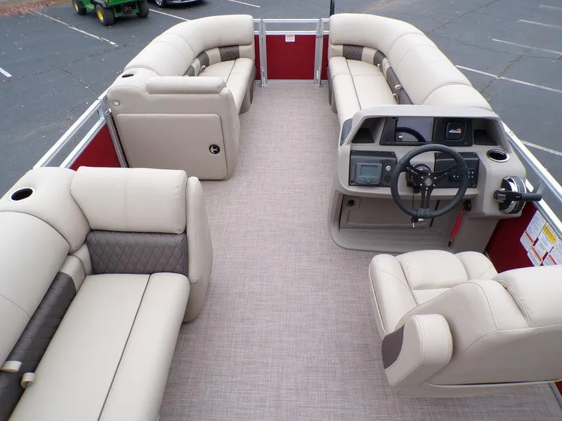 Slide: The Image of 2024 Sun Tracker PARTY BARGE® 20 DLX pontoon boat interior with beige seating and helm. - 19