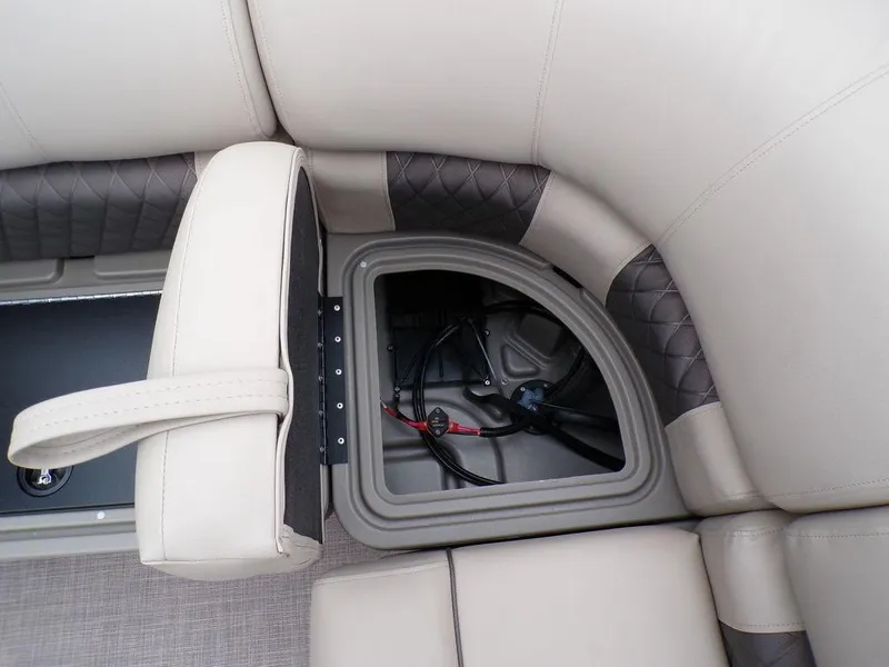 Slide: The Image of 2024 Sun Tracker PARTY BARGE® 20 DLX storage compartment with cushioned seating. - 21
