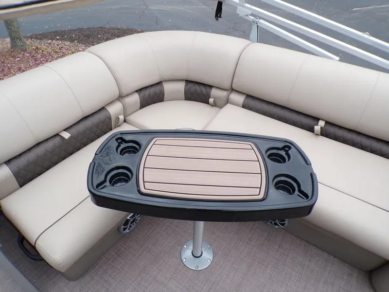 Slide: The Image of 2024 Sun Tracker PARTY BARGE® 20 DLX interior with cushioned seating and a central table. - 29