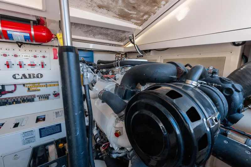Slide: The Image of Engine room of a 2013 Cabo 36 Express boat with visible machinery and control panels. - 11