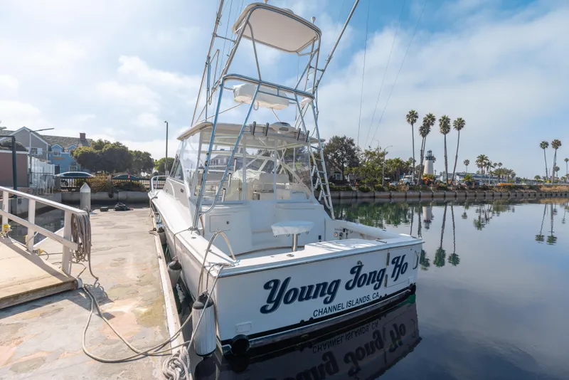 Slide: The Image of 2013 Cabo 36 Express boat docked at marina, rear view. - 24
