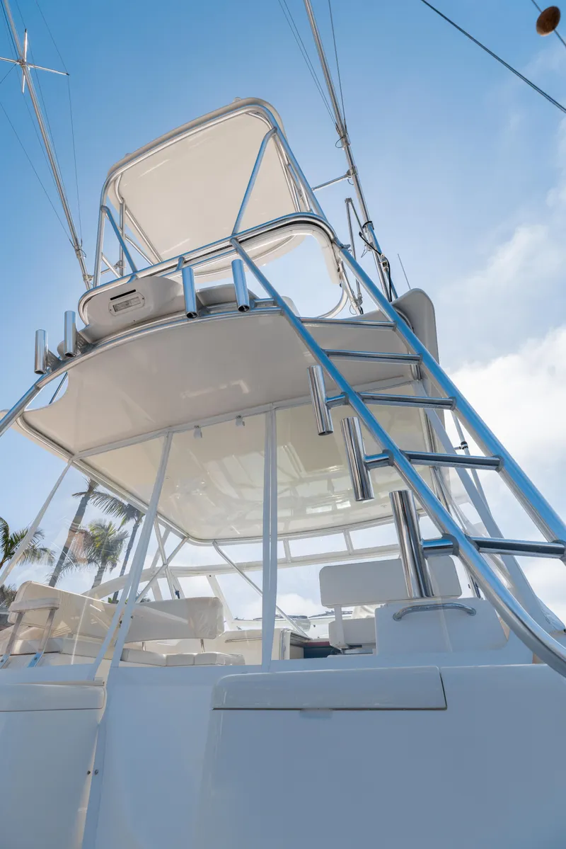 Slide: The Image of 2013 Cabo 36 Express boat with flybridge and ladder. - 5