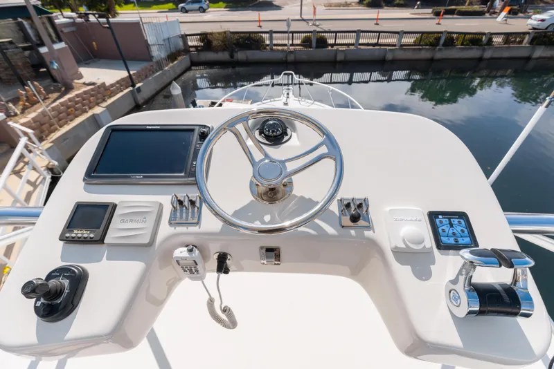 Slide: The Image of Helm station of 2013 Cabo 36 Express boat with steering wheel and navigation equipment. - 6