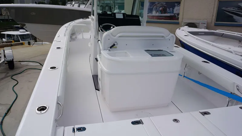 Slide: The Image of 2024 Everglades 273 CC center console boat interior with helm station and seating. - 12