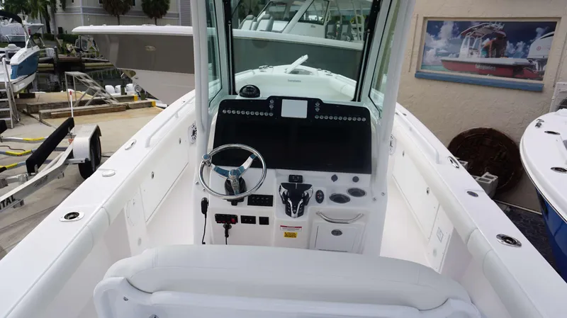 Slide: The Image of 2024 Everglades 273 CC boat dashboard and helm station at marina. - 13