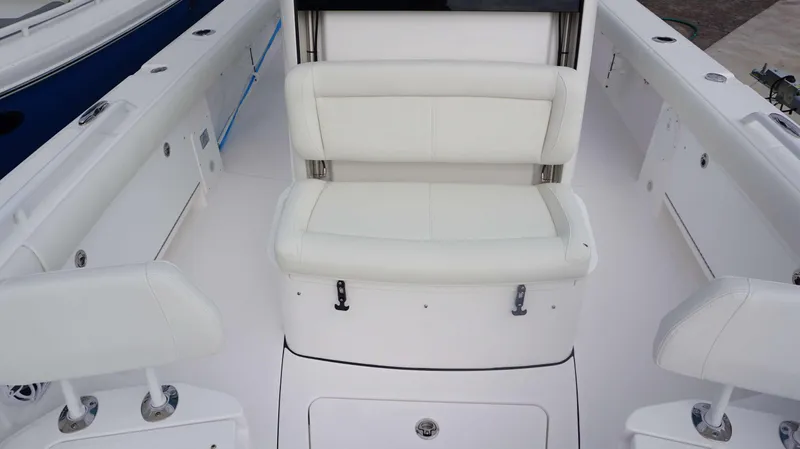 Slide: The Image of 2024 Everglades 273 CC boat interior with white seating and storage compartments. - 17