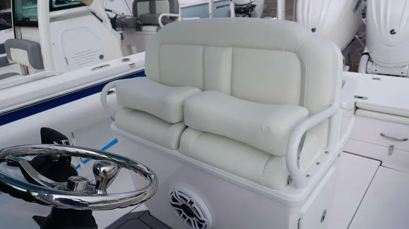 Slide: The Image of 2024 Everglades 273 CC boat helm with cushioned seating and stainless steel steering wheel. - 19