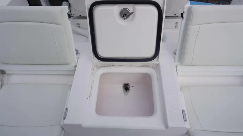 Slide: The Image of Open storage compartment on the 2024 Everglades 273 CC boat. - 2