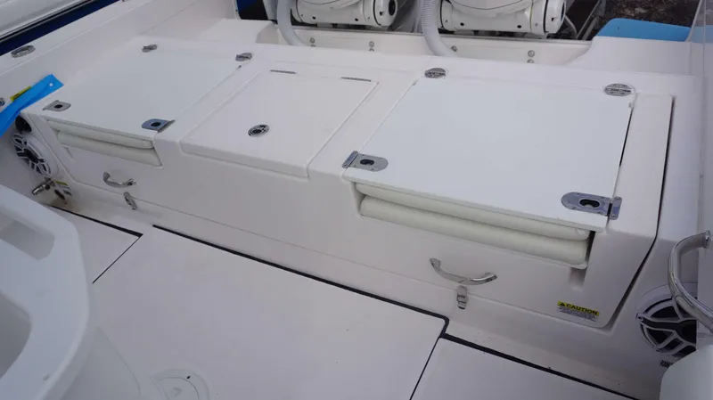 Slide: The Image of 2024 Everglades 273 CC boat deck with storage compartments and seating. - 20