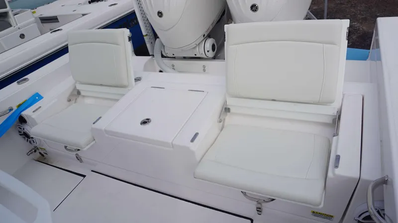 Slide: The Image of 2024 Everglades 273 CC boat with white cushioned seating and dual outboard motors. - 21