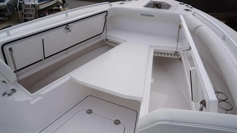 Slide: The Image of 2024 Everglades 273 CC boat interior with open storage compartments and seating area. - 5
