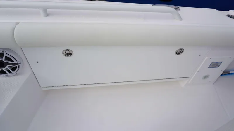 Slide: The Image of 2024 Everglades 273 CC boat interior detail with speaker and storage compartment. - 7