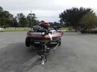 Slide: The Image of 2024 Ranger Z519 boat on a trailer in a parking lot. - 2