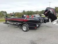Slide: The Image of 2024 Ranger Z519 boat with trailer, black and red, side view. - 3