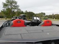 Slide: The Image of 2024 Ranger Z519 boat with red and black seats, parked outdoors. - 5
