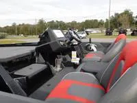 Slide: The Image of 2024 Ranger Z519 boat interior with red and gray seats and control console. - 9