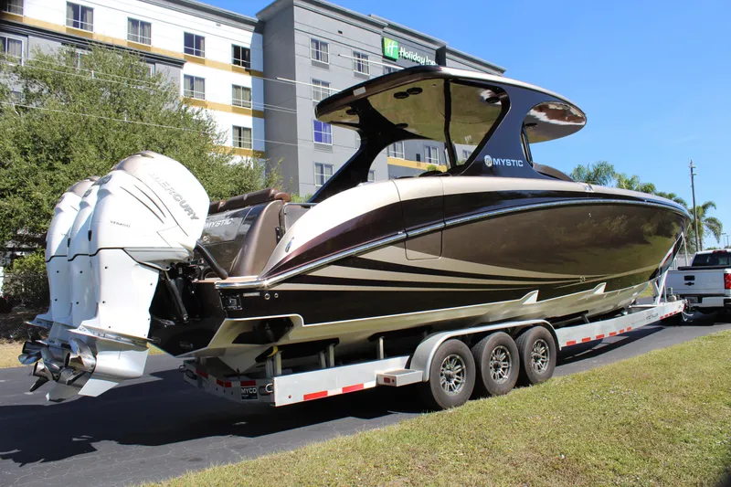 Slide: The Image of 2016 Mystic Powerboats M4200 on trailer, parked near a hotel. - 14