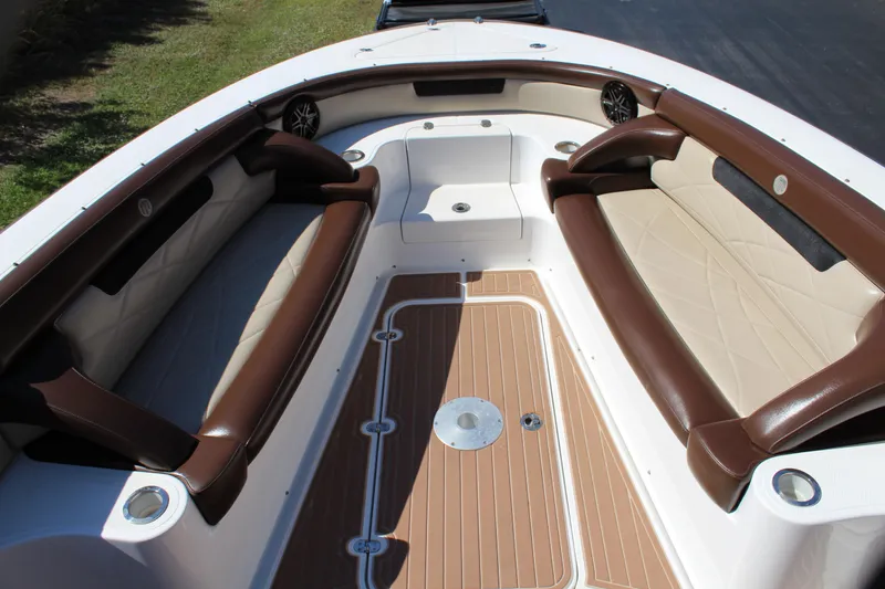 Slide: The Image of 2016 Mystic Powerboats M4200 bow seating area with brown and beige upholstery. - 19