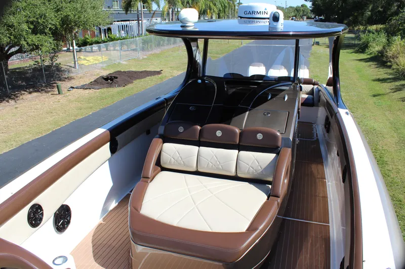Slide: The Image of 2016 Mystic Powerboats M4200 interior with luxurious seating and Garmin navigation system. - 23