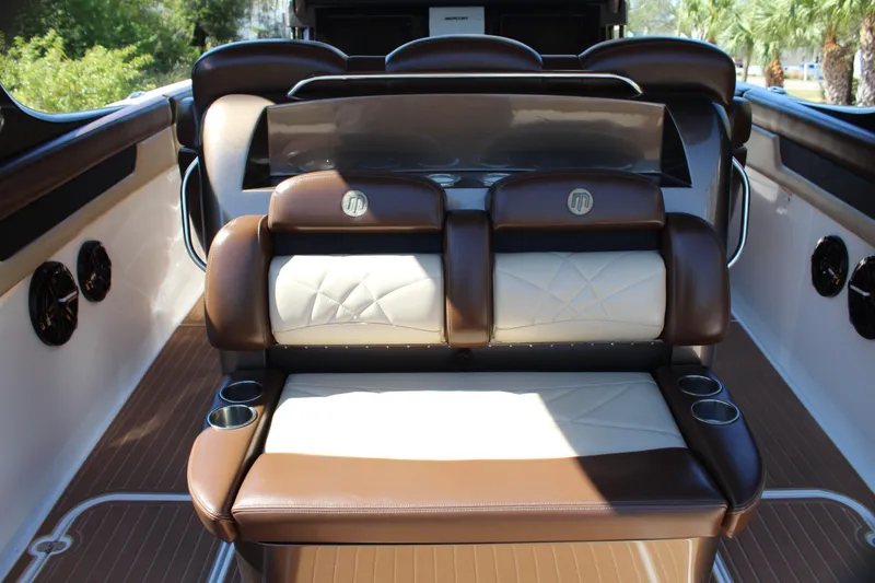 Slide: The Image of 2016 Mystic Powerboats M4200 interior seating with brown and white leather upholstery. - 25