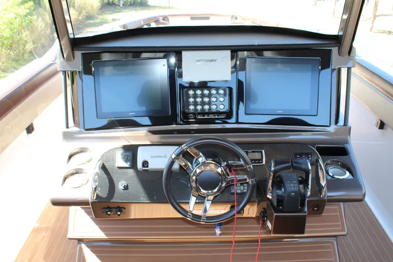 Slide: The Image of 2016 Mystic Powerboats M4200 helm with dual displays and advanced controls. - 28